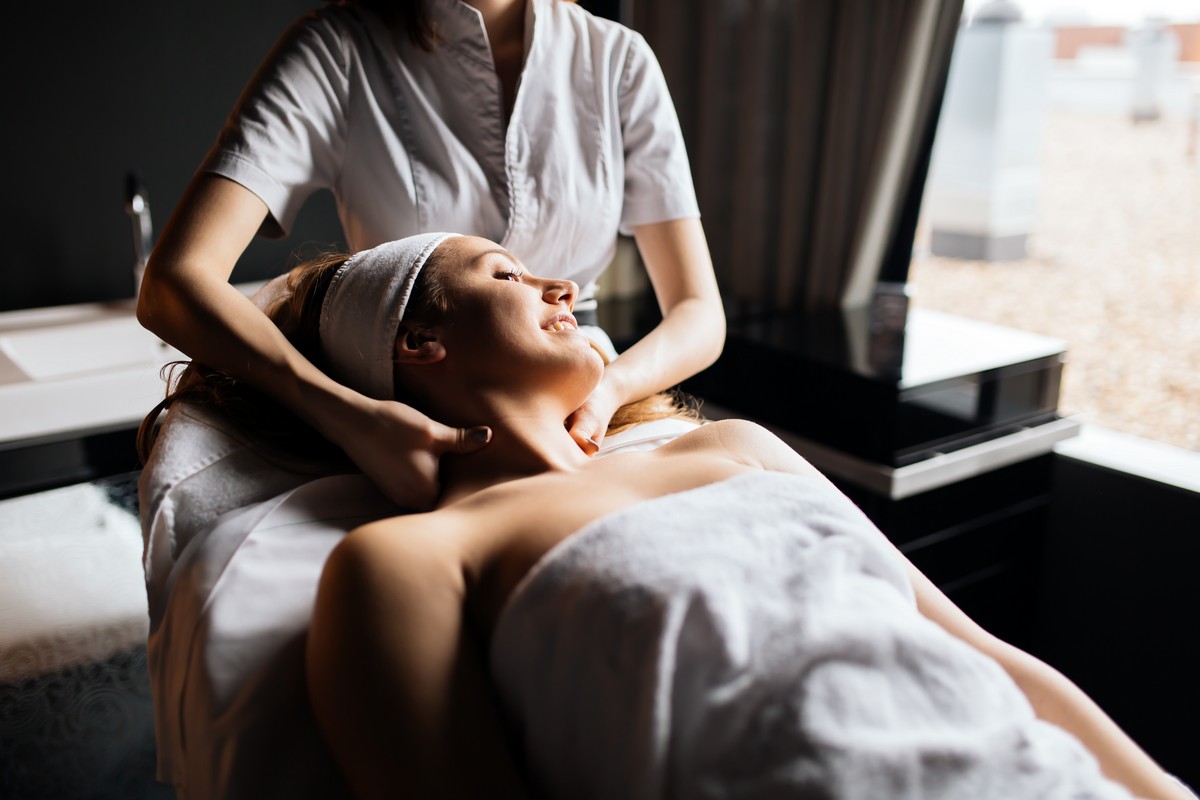 Beautiful young and cute woman enjoying massage treatment